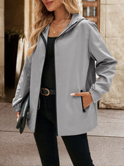Gray zip-through hooded jacket with black trim and zippered pockets.