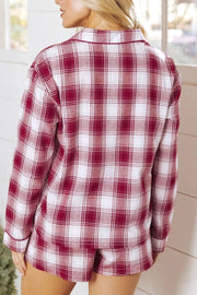 Cozy red plaid cotton pajama set with buttoned top and shorts.