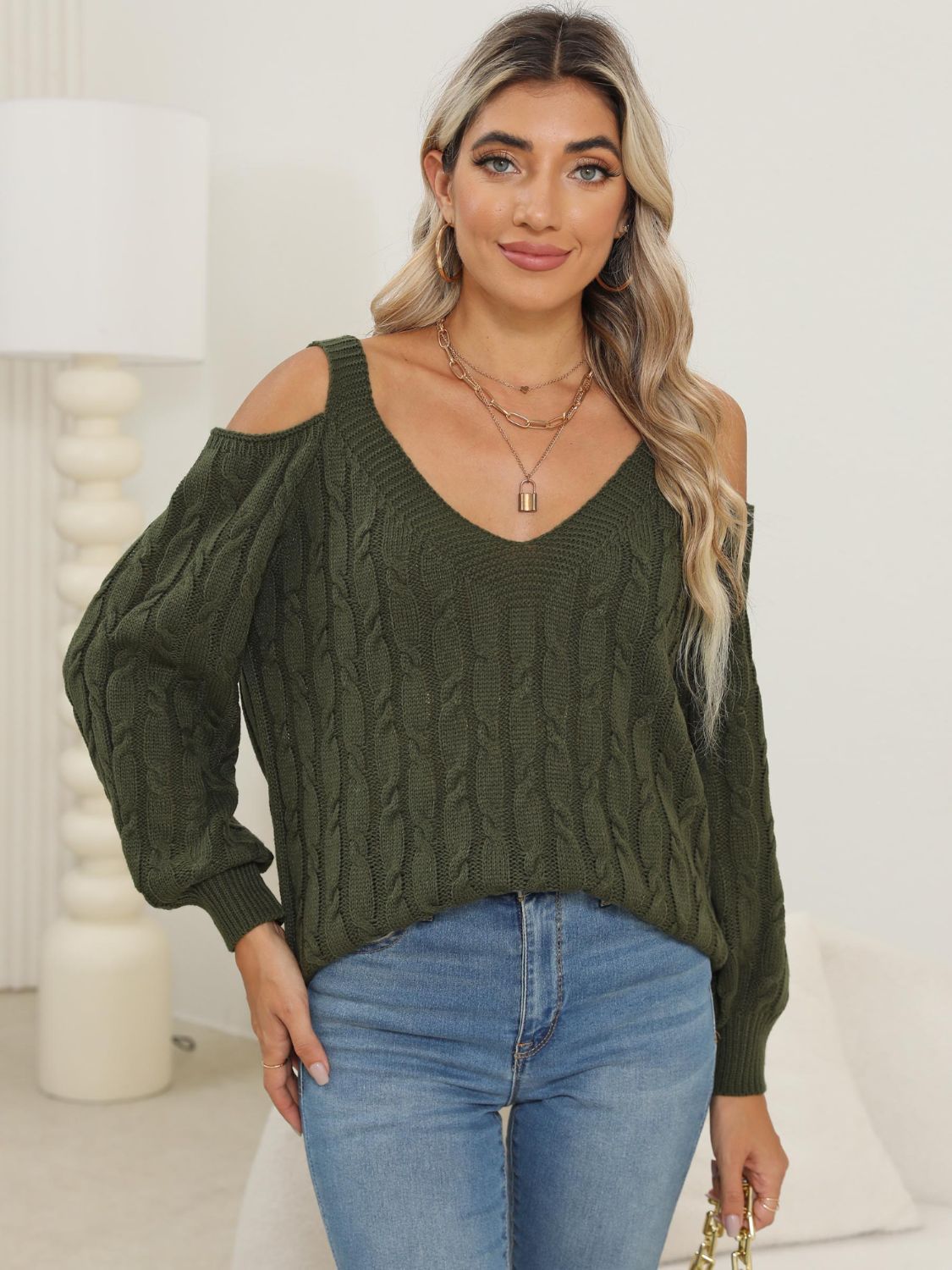 Army green cable knit cold shoulder sweater with balloon sleeves and V-neck.