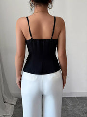 Black cami with square neckline, adjustable straps, and button front detail.