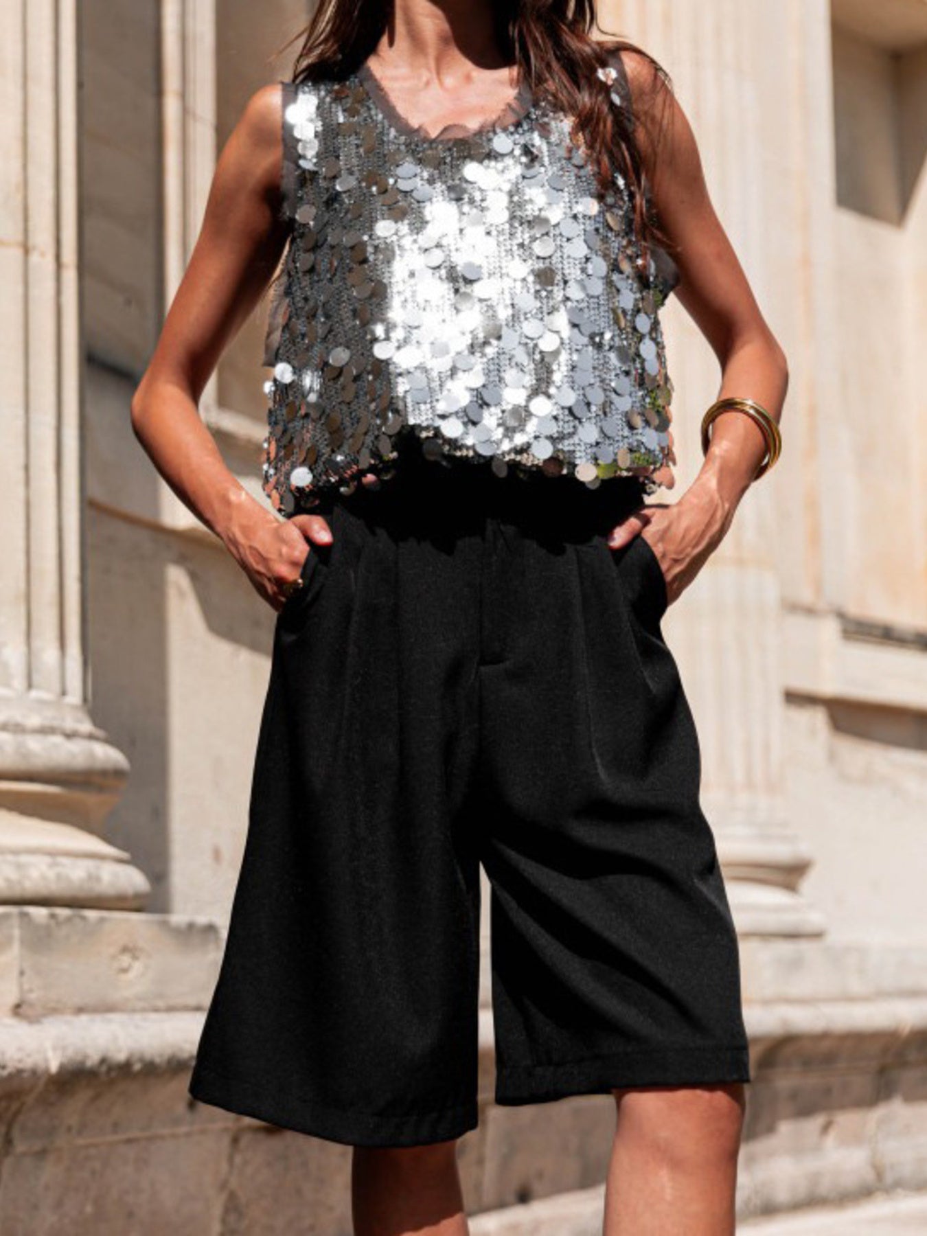Dazzling sequin embellished tank top in silver with a ruffled neckline.
