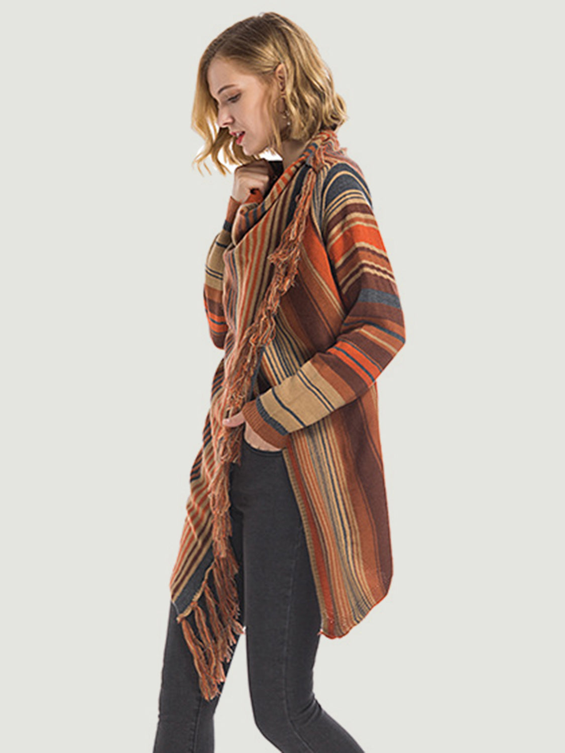 Asymmetric fringe stripe cardigan in ochre with draped neckline and acrylic knit.