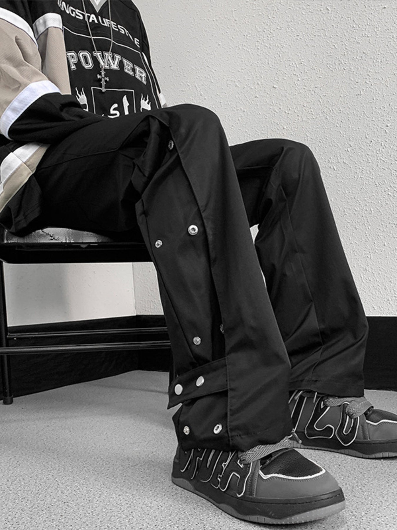 Men's black snap button loose fit sweatpants with adjustable waist.