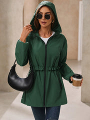 Dark green hooded windbreaker jacket with ruffled drawstring waist and zip front.