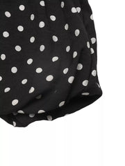 Black polka dot dress with ruffled hem detail