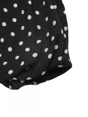 Black polka dot dress with ruffled hem detail