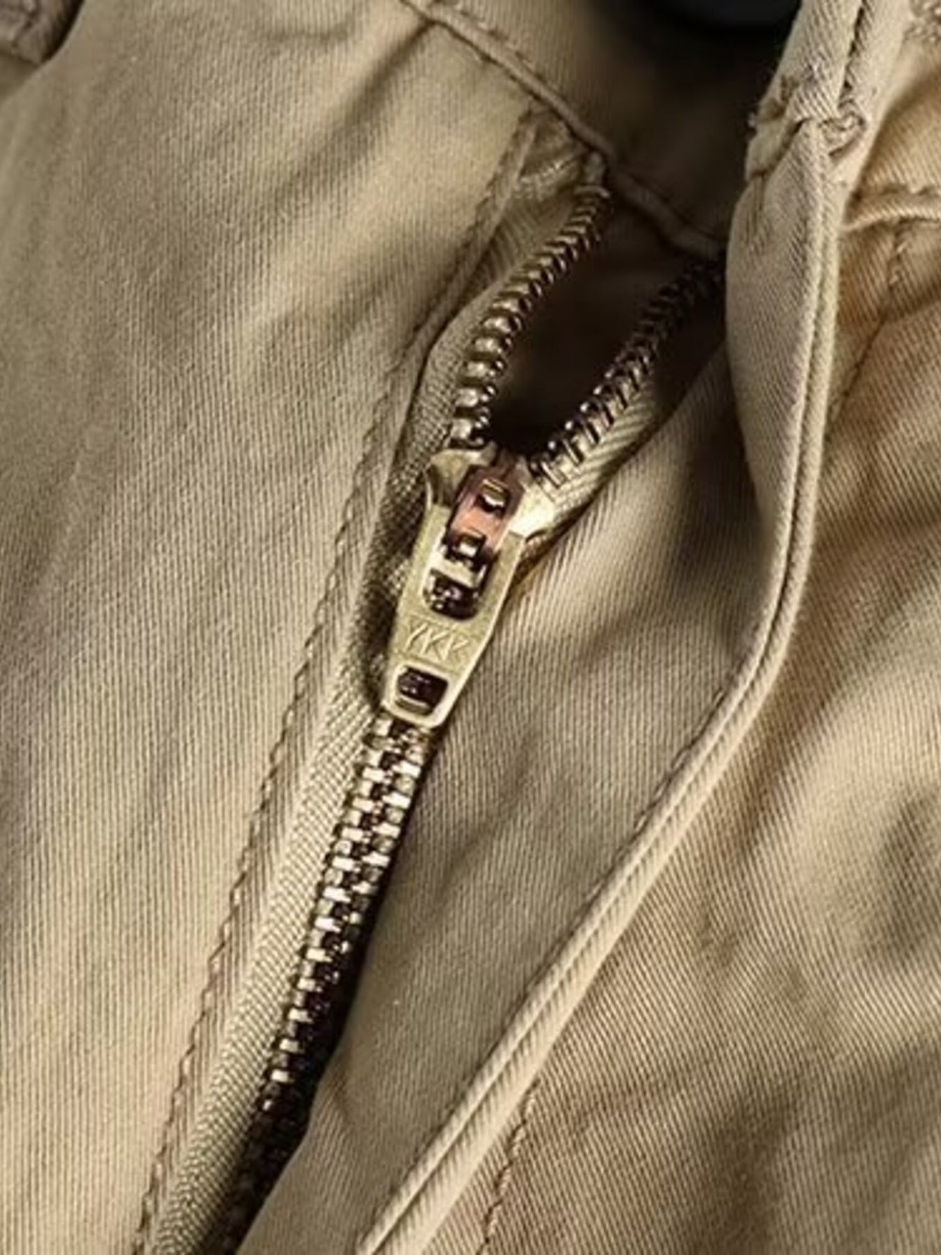 Khaki cargo pants with a YKK zipper detail