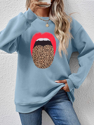Light blue sweatshirt with red lips and leopard tongue graphic.