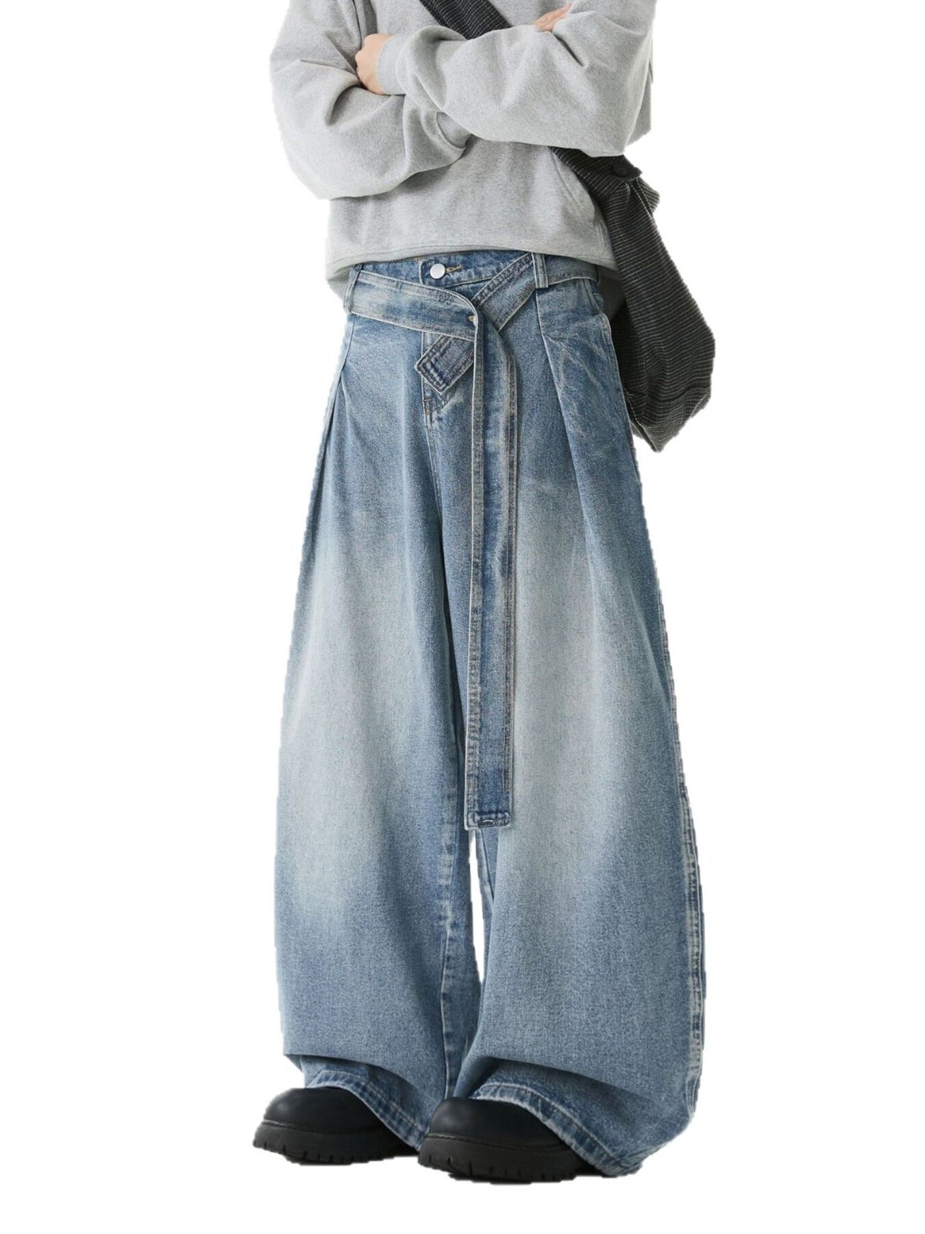 Belted relaxed fit men's jeans in light blue denim with a wide leg and tie waist.