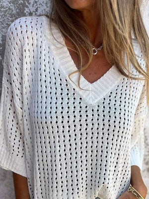 White open-knit V-neck sweater with short sleeves and a relaxed fit.