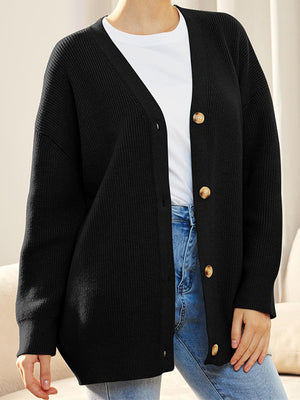 Black ribbed knit cardigan with balloon sleeves and button front, styled with a white tee and jeans.