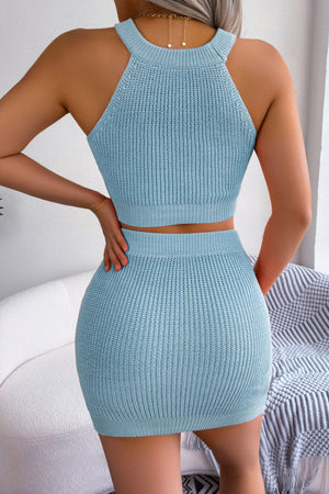 Sky blue knit halter crop top and mini skirt set with ribbed texture and gold heart necklace detail.