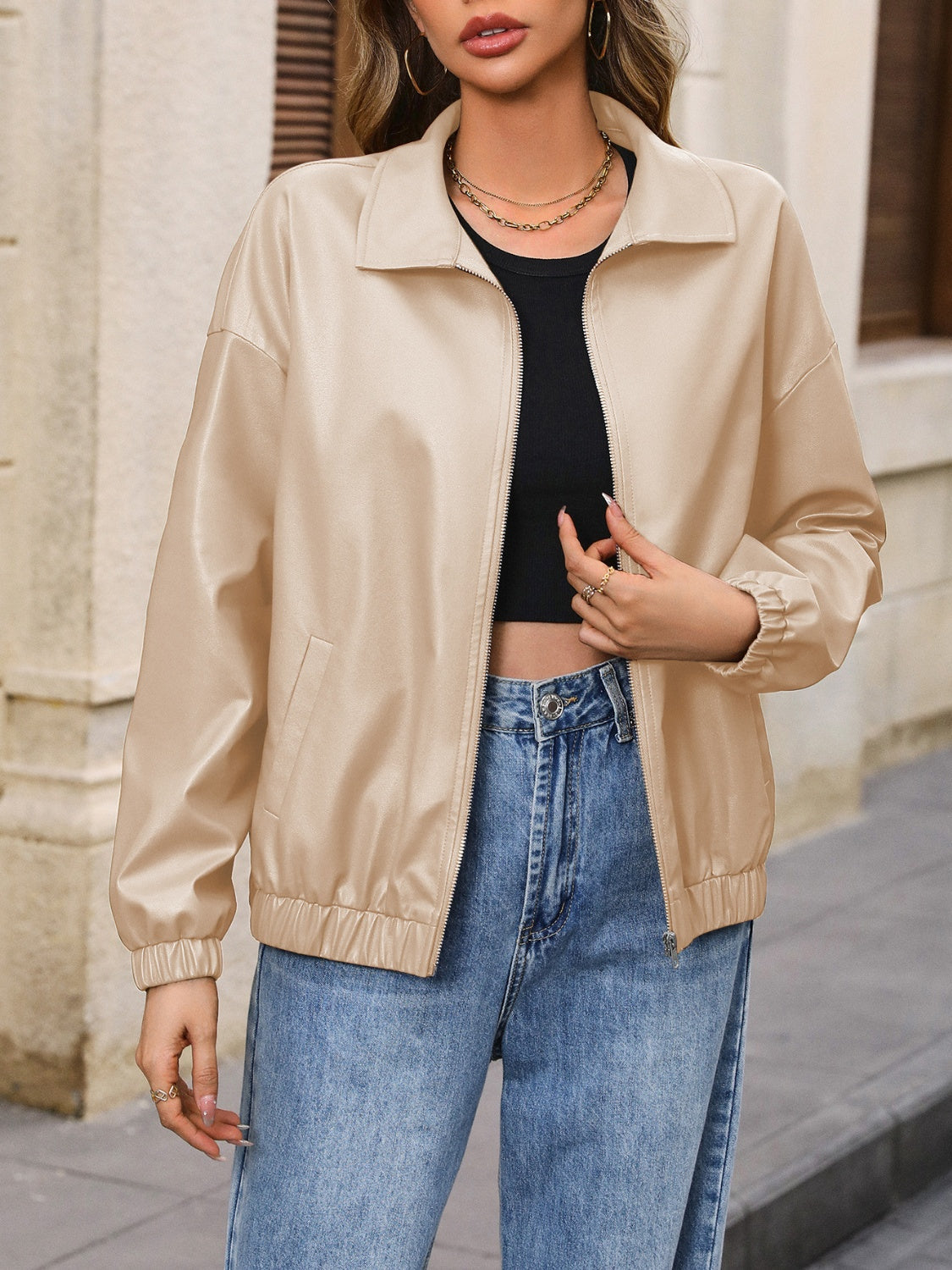 Tan faux leather bomber jacket with zip front and elastic cuffs and hem.