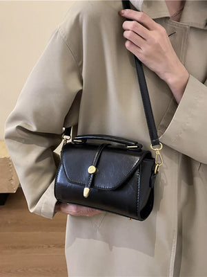 Black mini pu leather crossbody bag with gold clasp and top handle