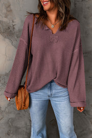 Dusty purple waffle knit V-neck pullover sweater with long sleeves.