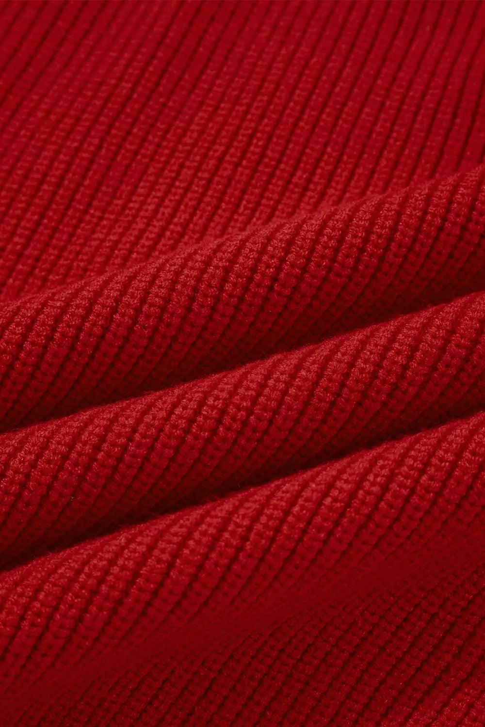 Red knit sweater with ribbed texture and backless bow detail.