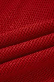 Red knit sweater with ribbed texture and backless bow detail.