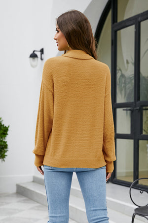 Textured turtleneck sweater in tan with long sleeves and a relaxed fit.