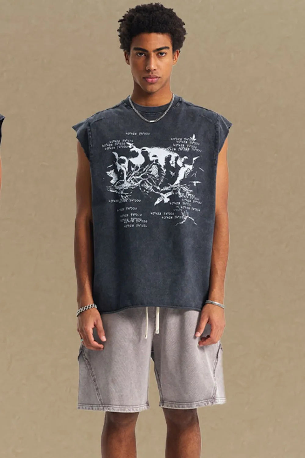 Black washed graphic sleeveless tee with raw edges and a distressed print.