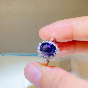 Amethyst sunburst moissanite ring in 925 sterling silver with a halo of white stones.