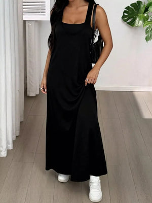 Black scoop neck cami maxi dress with tank straps and a flowing skirt.