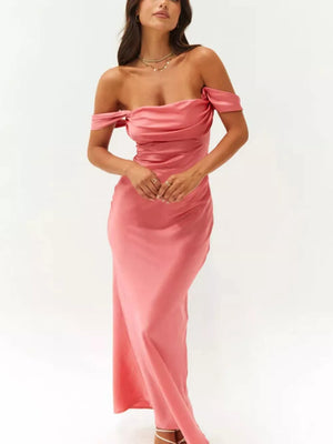 Satin off-shoulder maxi gown in coral with draped neckline and bodycon fit.