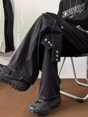 Men's relaxed-fit black cargo pants with snap button details on the leg.