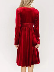 Red velvet midi dress with smocked waist and long sleeves, shown from the back.