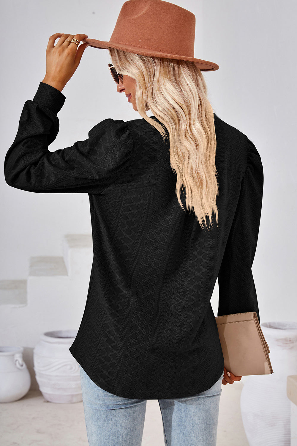 Black textured puff sleeve henley blouse with a subtle geometric pattern.