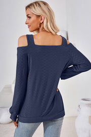 Dark blue geometric cutout shoulder top with long sleeves and textured fabric.