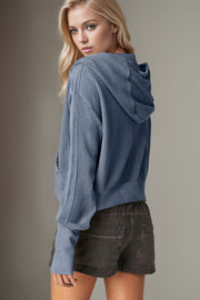 Textured knit bomber hoodie in dusty blue with waffle texture and front pockets.