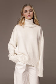 Oversized white cashmere turtleneck sweater with ribbed cuffs and hem.