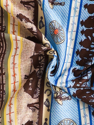 Children's cotton tee and shorts set with western print, featuring horses, wagons, and cowboy motifs.