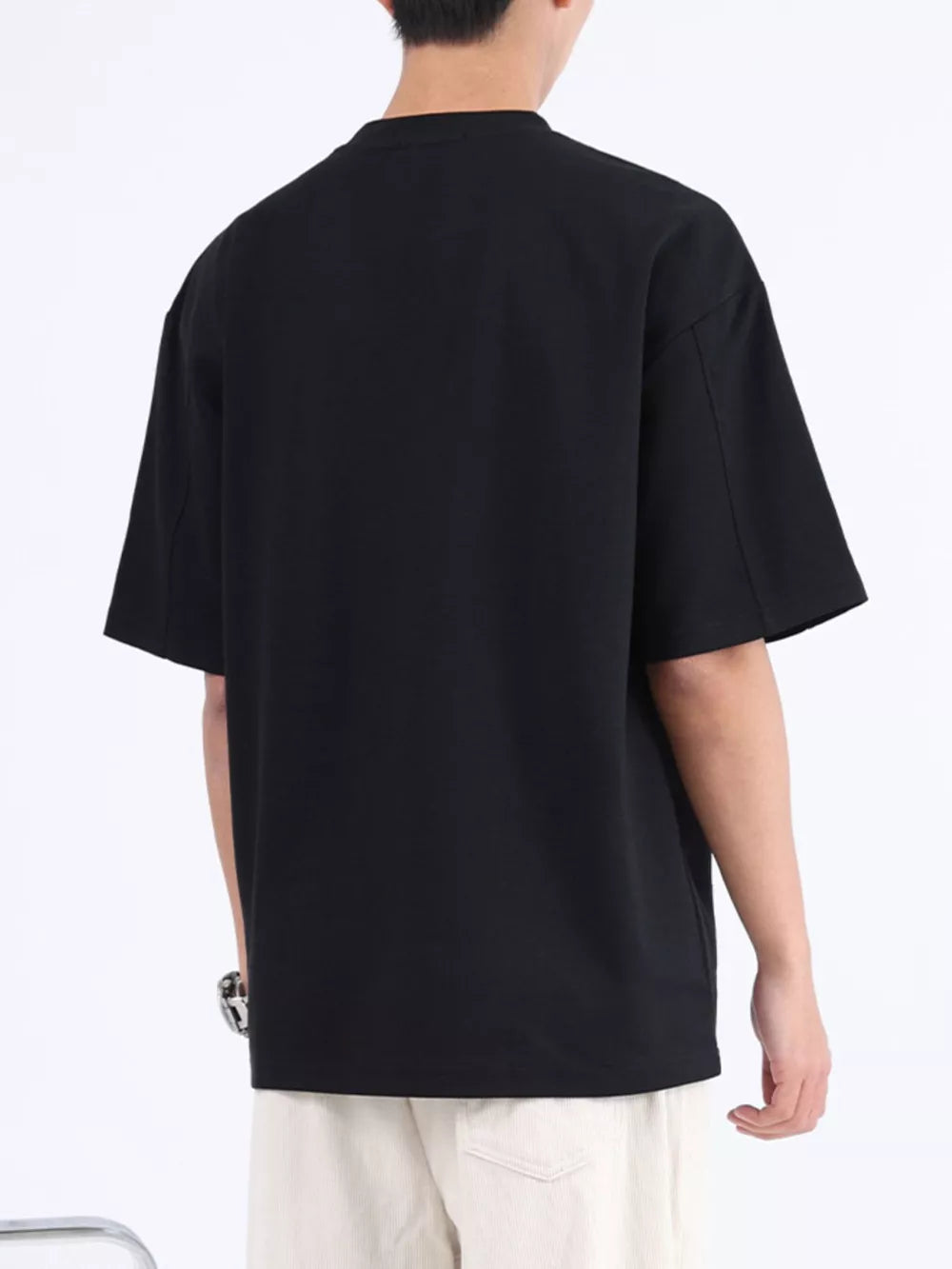 Black cotton crew neck oversized t-shirt with short sleeves, shown from the back.