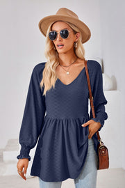 Dark blue textured babydoll blouse with v-neck and smocked cuffs