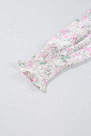 Blush pink floral print blouse with smocked waist detail and long sleeves