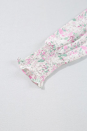 Blush pink floral print blouse with smocked waist detail and long sleeves