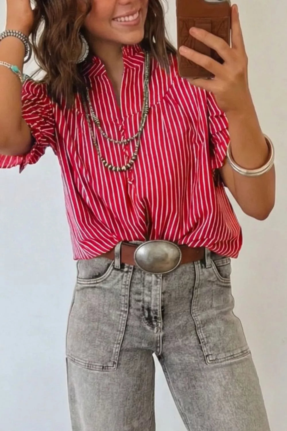 Chic red and white striped cotton shirt with ruffled sleeves and button detail.
