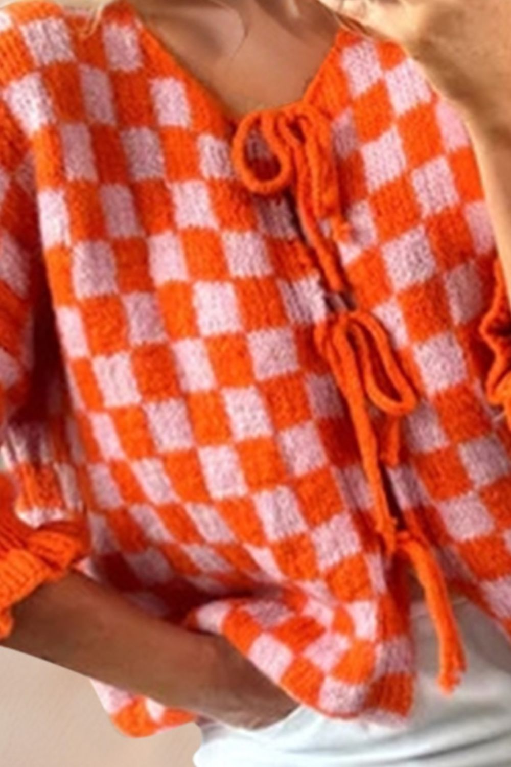 Orange and pink checkered knit cardigan with tie front and ruffle sleeves