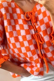 Orange and pink checkered knit cardigan with tie front and ruffle sleeves
