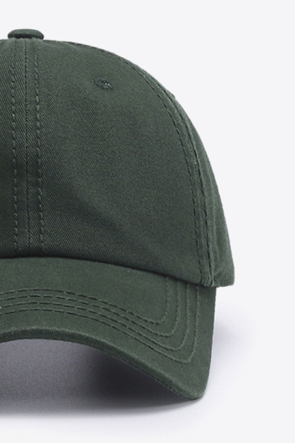 Green canvas baseball cap with stitched details on the brim.