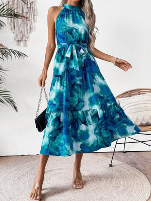 Blue floral halter neck midi dress with tiered skirt and tie belt.