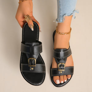 Chic black PU leather slide sandals with buckle detail and white contrast stitching.