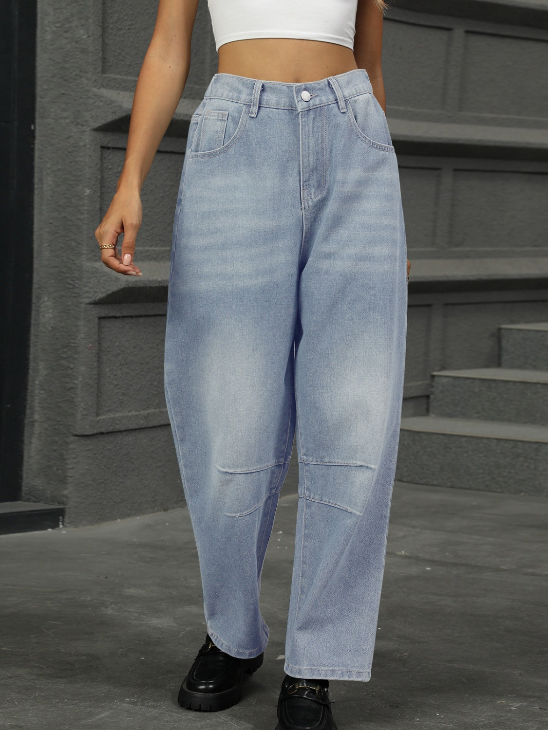 Relaxed light wash denim trousers with patchwork knee detail and wide leg.