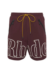 Burgundy cargo shorts with white "Rhude" logo and yellow drawstring.