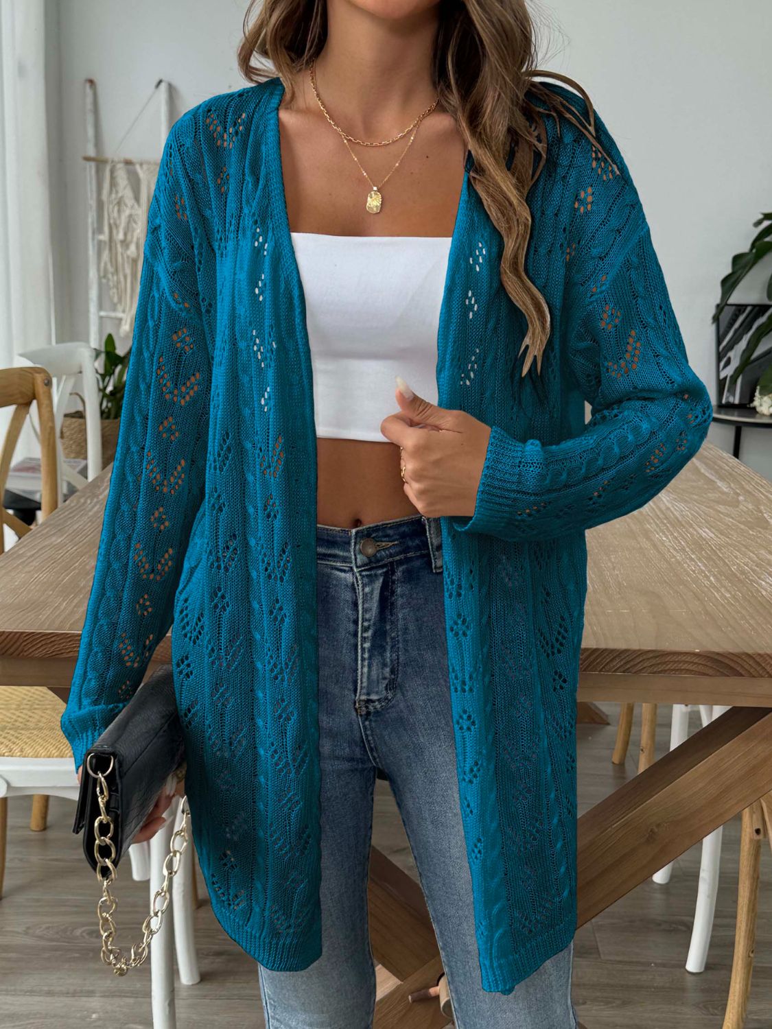 Peacock blue openwork diamond knit duster cardigan with long sleeves and open front.
