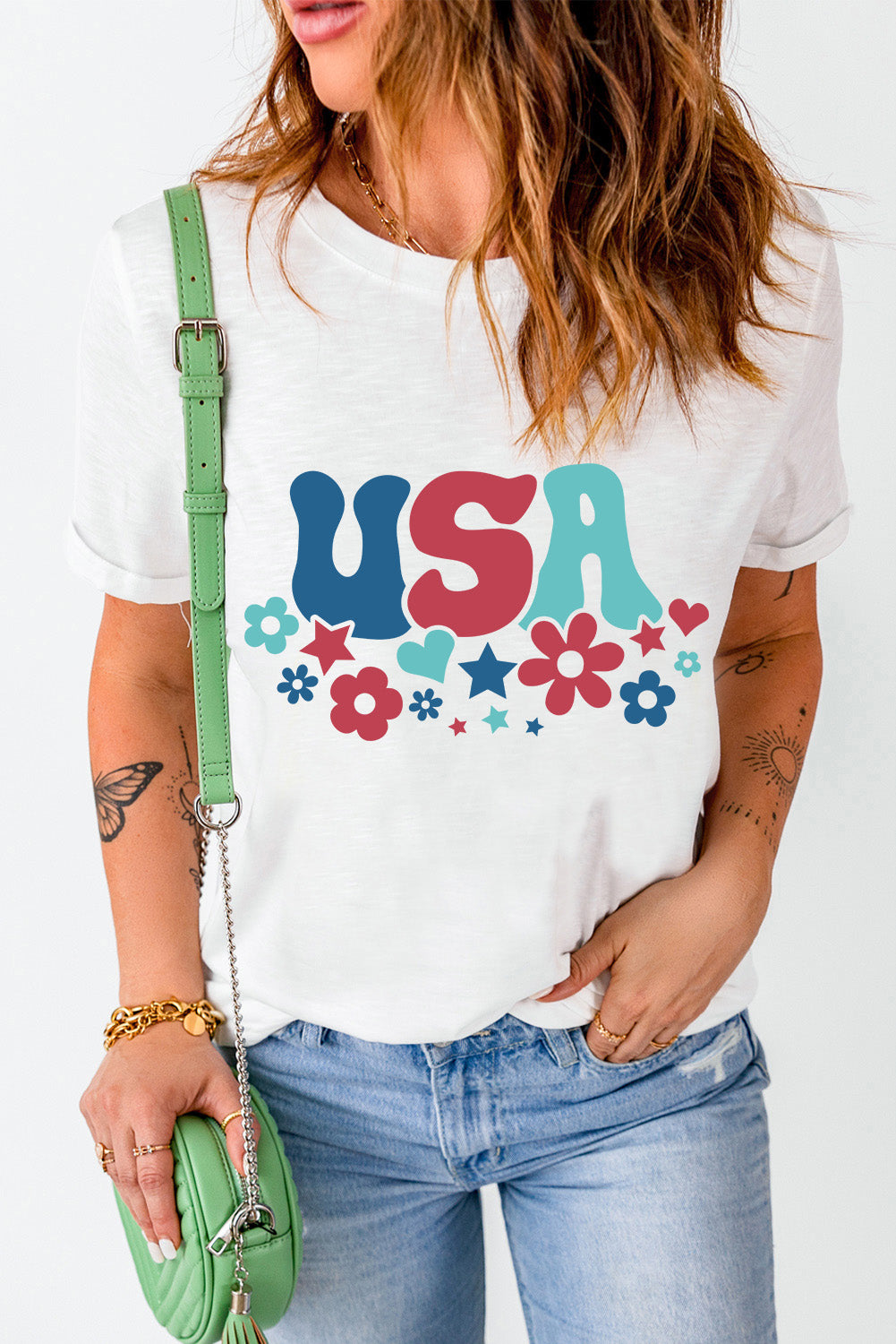 White graphic t-shirt with groovy USA text and floral pattern