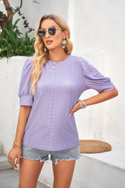 Lavender eyelet puff sleeve blouse with textured fabric and round neckline.