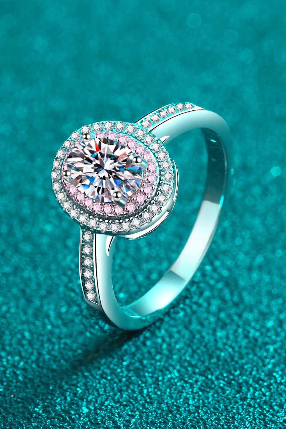 Silver ring with oval halo and pink stone accents