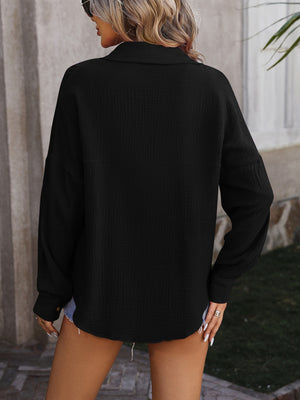 Black textured cotton overshirt with relaxed silhouette and button cuffs.